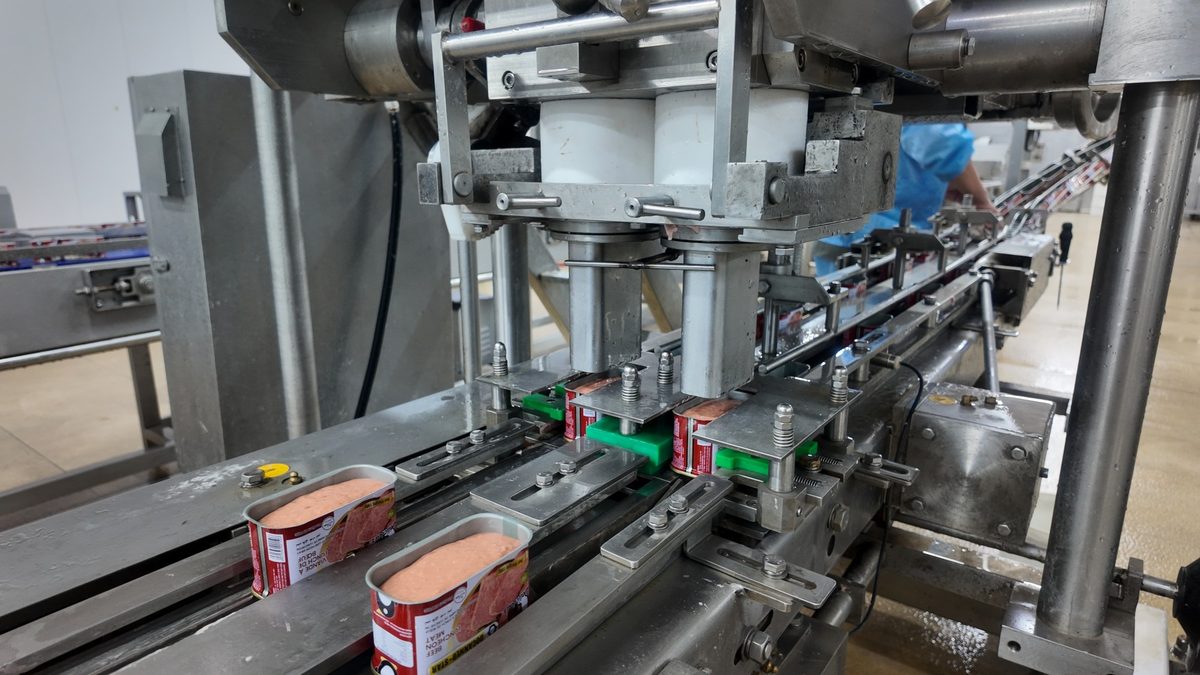 Beef luncheon meat cans at the seamer