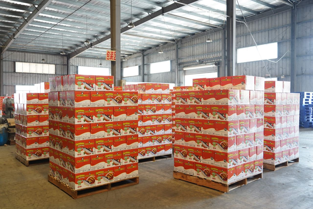 Pallets of DocannedStar sardines in tomato sauce cartons in the Docanned warehouse